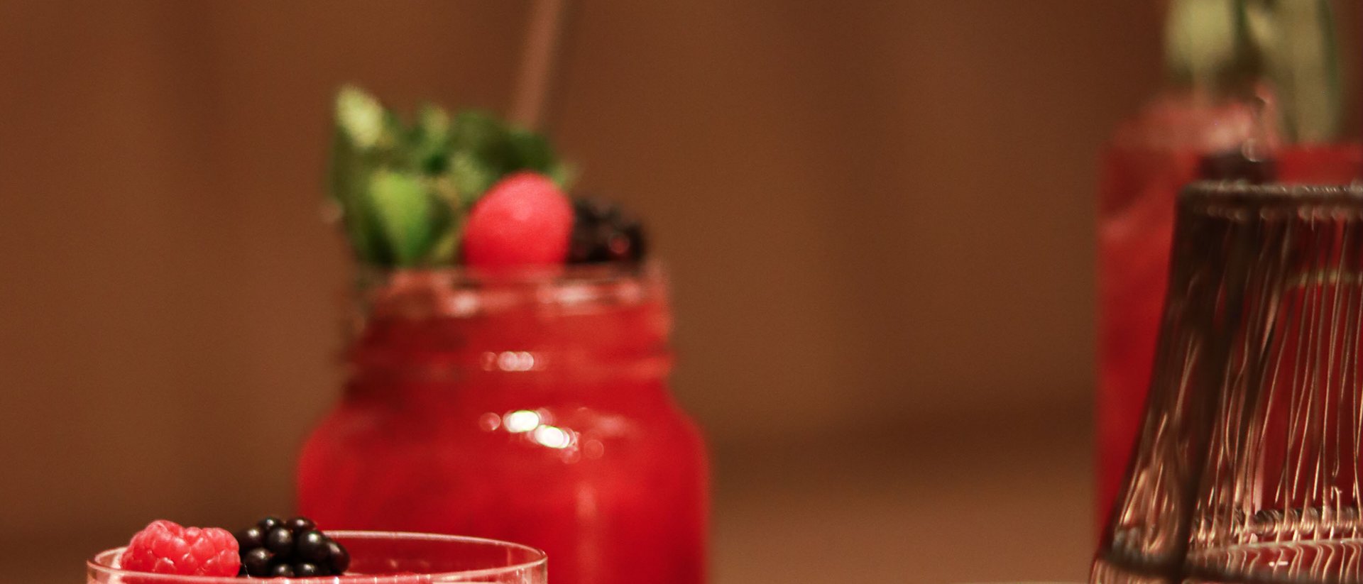 Red berry cocktails in glasses on a white table