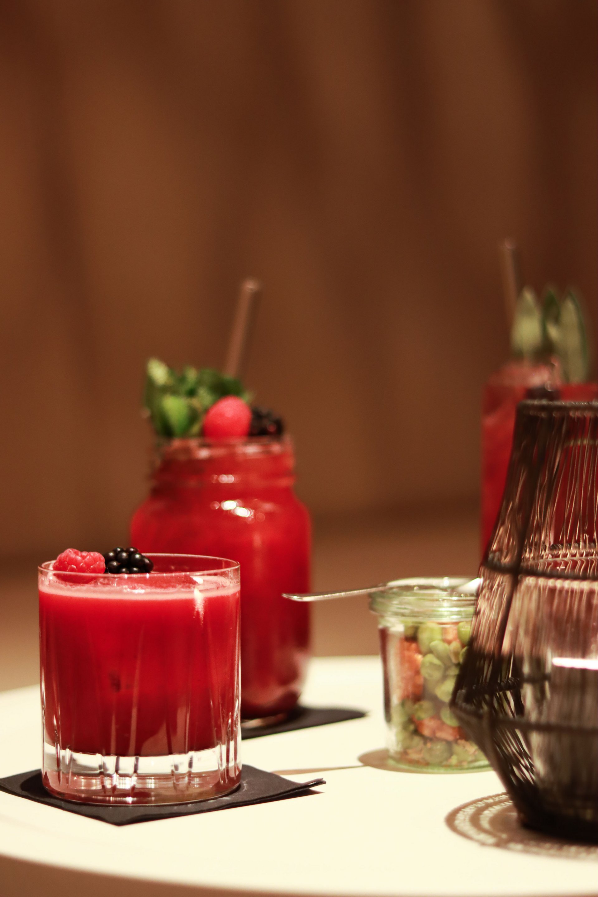 Cocktails aux baies rouges dans des verres sur une table blanche