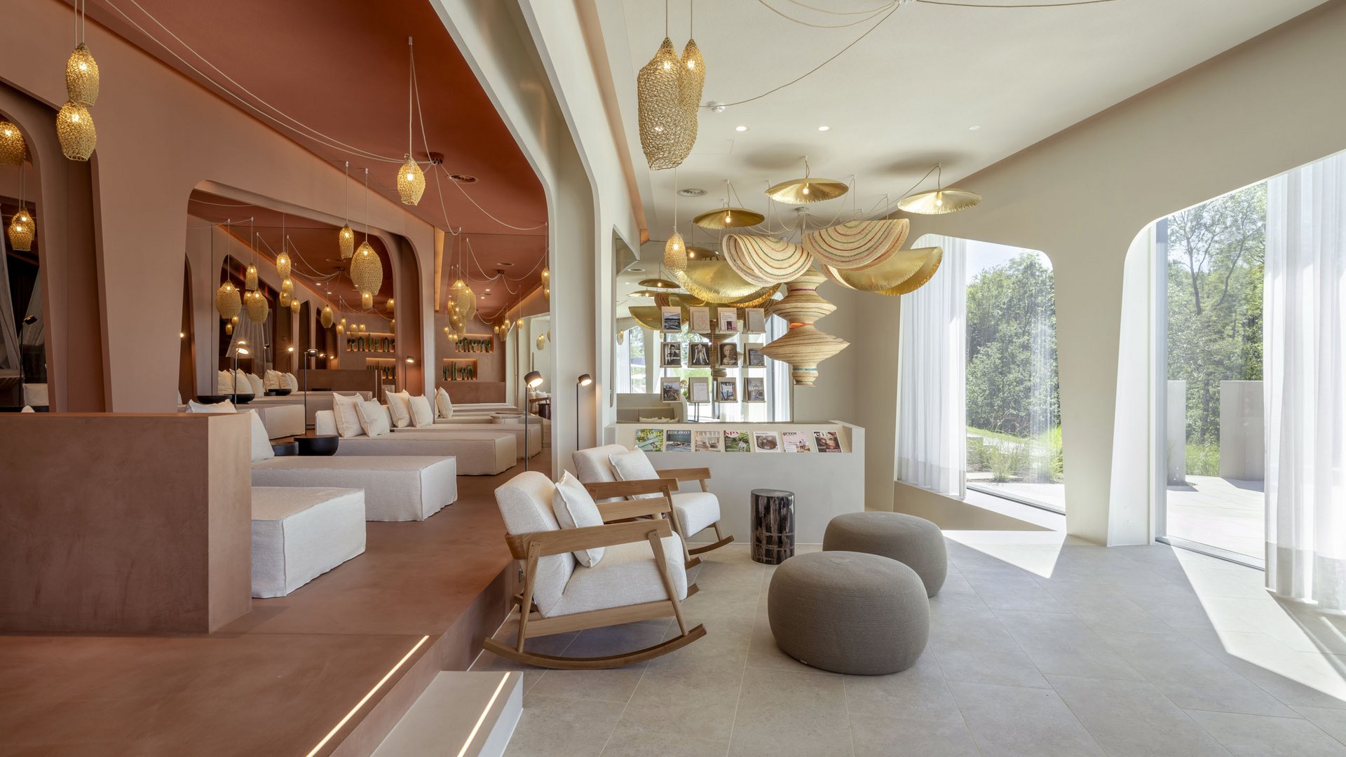 Bright lounge with cozy chairs, poufs, and decorative hanging lights