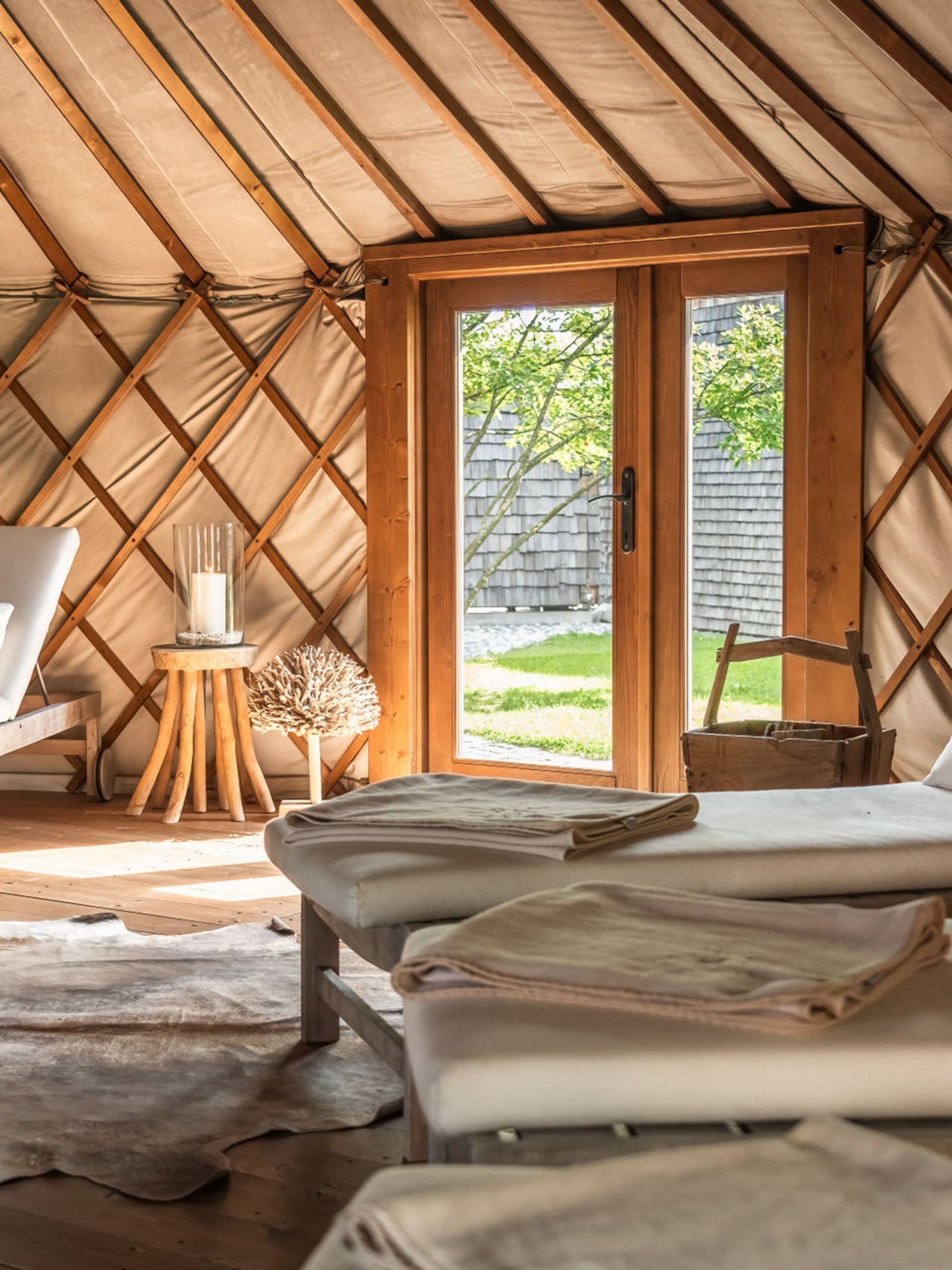 Cozy relaxation room with loungers in a wooden yurt with outdoor view
