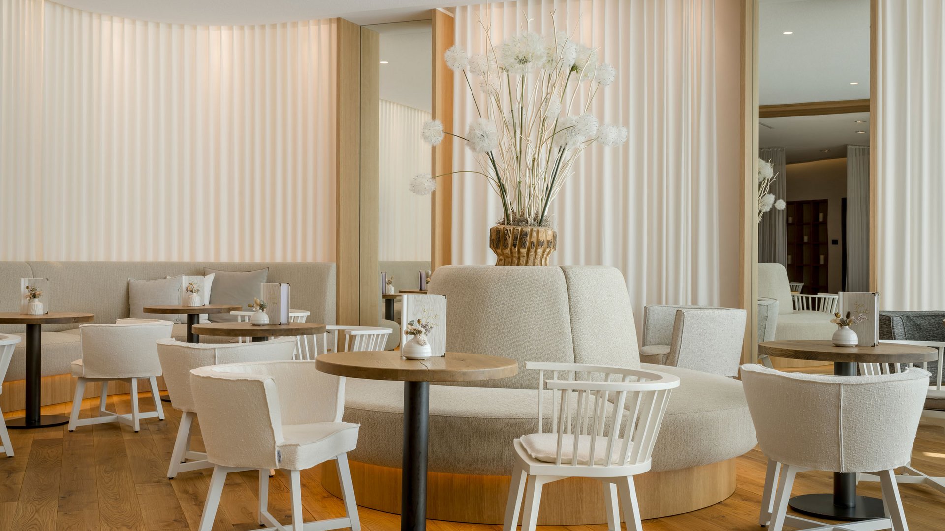 Café moderne et lumineux avec meubles blancs et décor floral