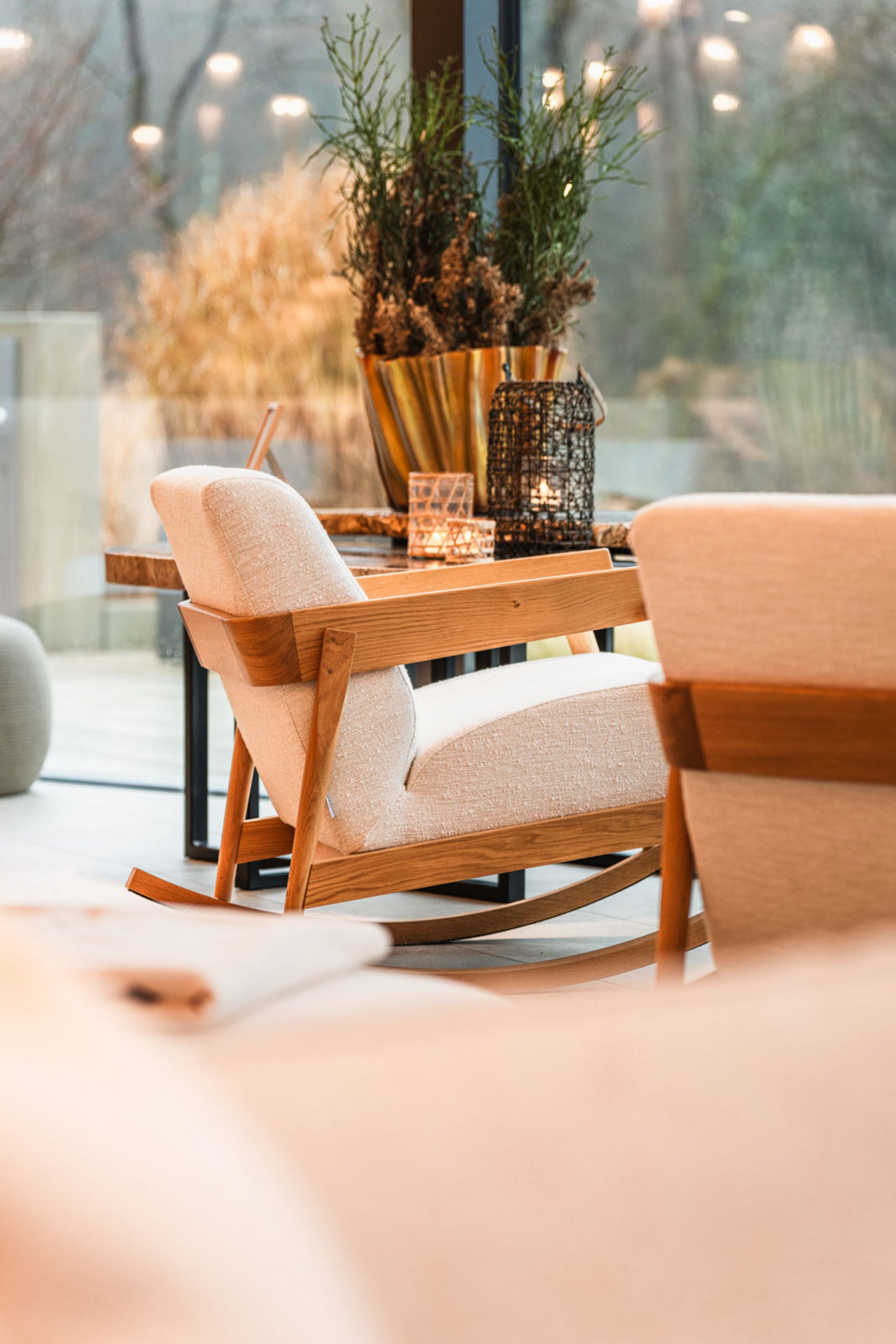 Modern wooden and fabric rocking chair in a bright living room