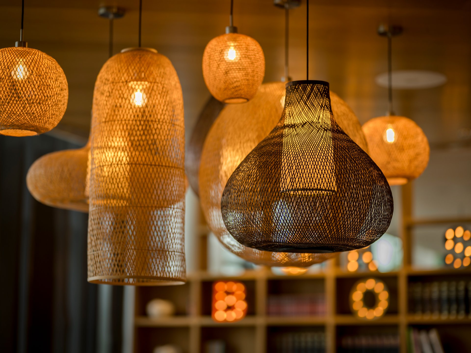 Various glowing woven hanging lamps emitting warm light