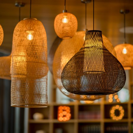 Various glowing woven hanging lamps emitting warm light
