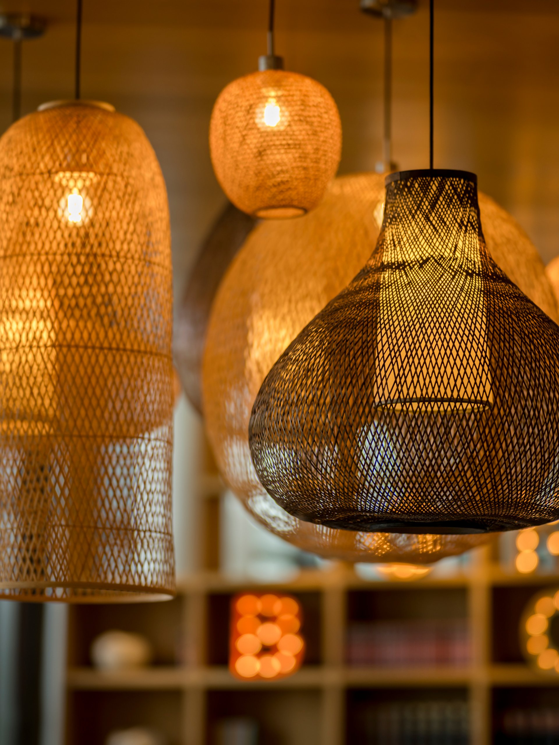 Various glowing woven hanging lamps emitting warm light