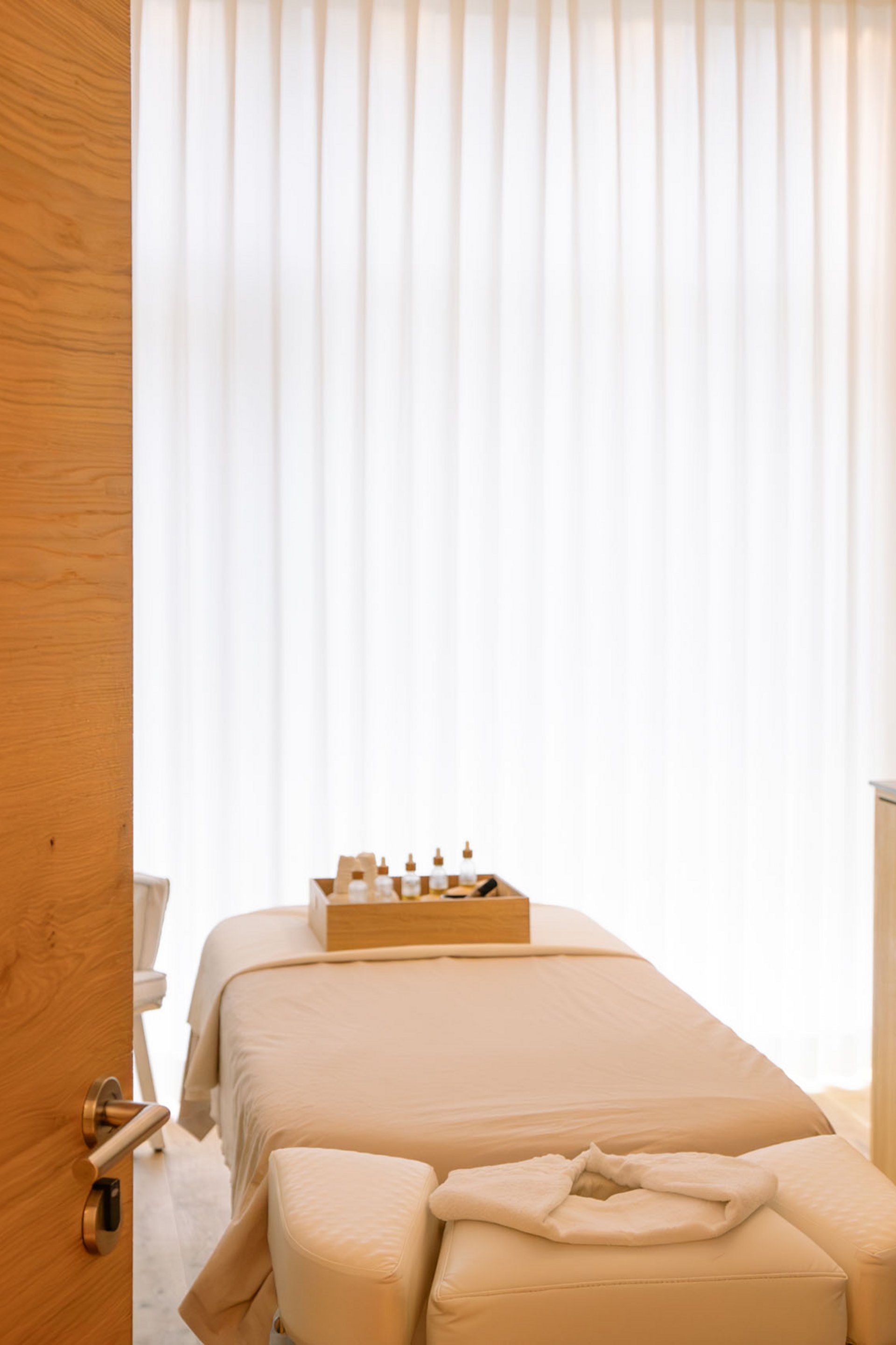 Massageraum mit Behandlungsliege, Kerzen und Aromastoffen für Ruhe