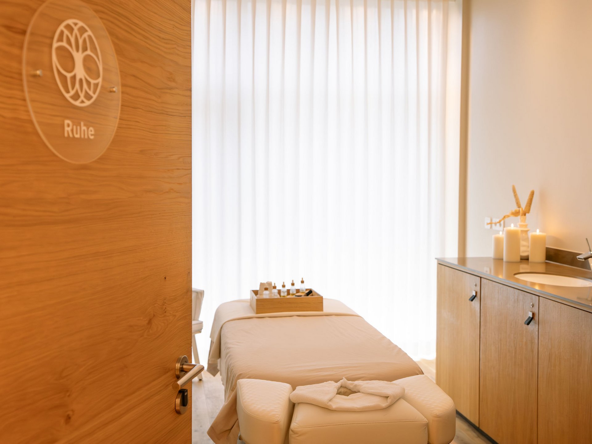 Massage room with treatment table, candles, and aromatherapy for relaxation