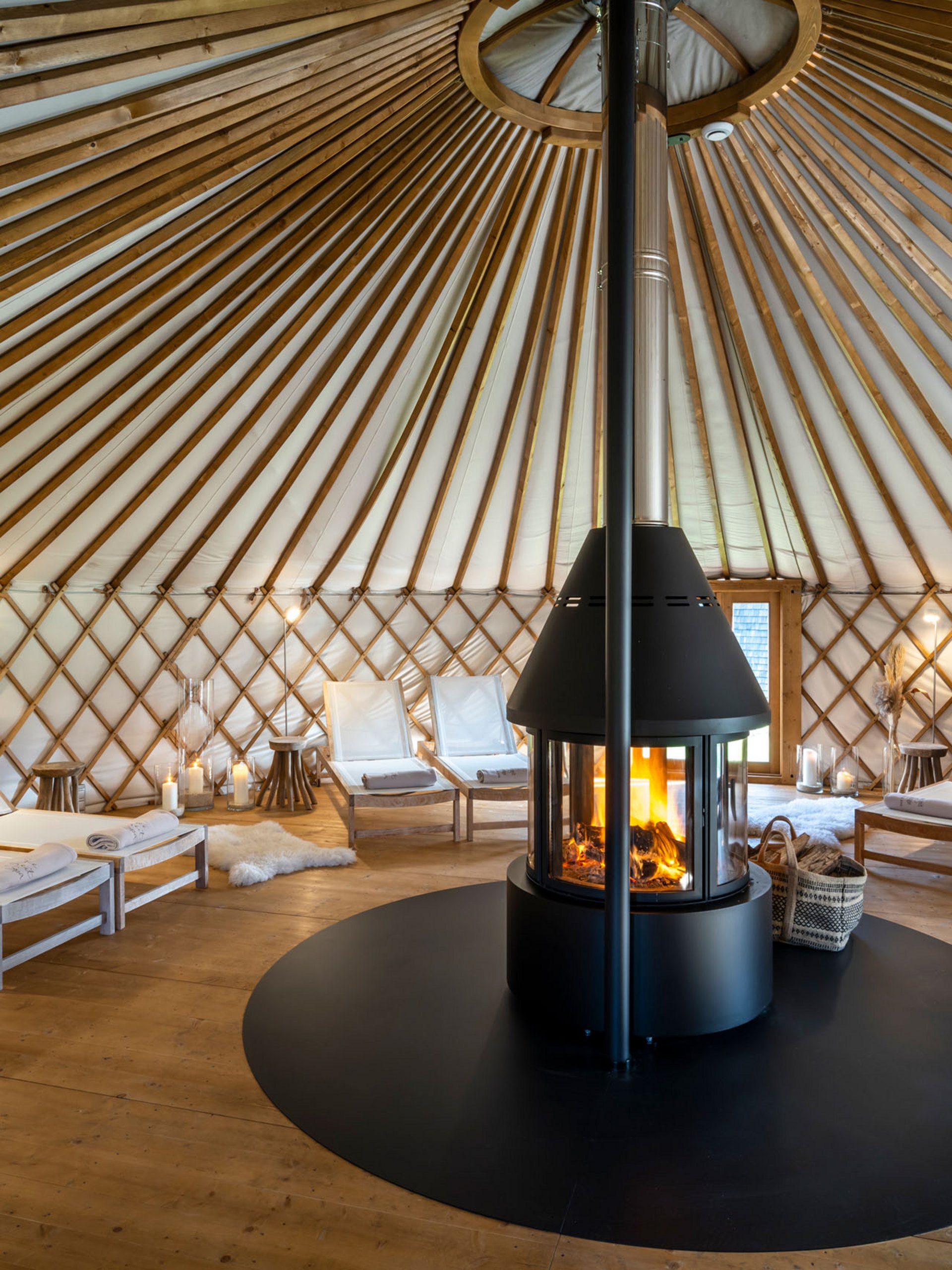 Interior of a yurt with fireplace and lounge chairs