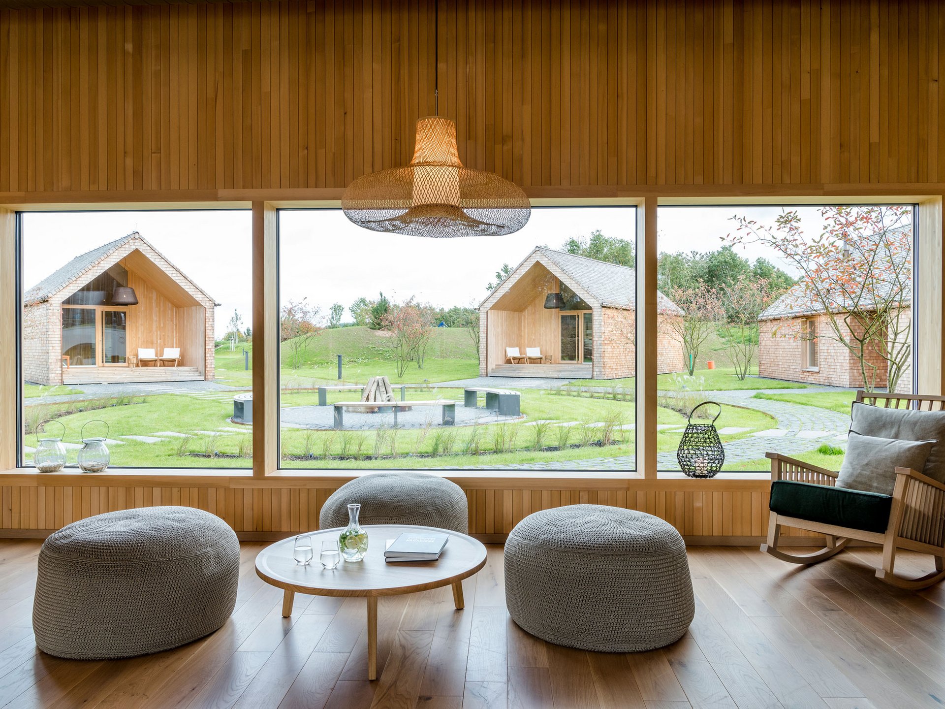 Modern living room with large windows overlooking garden and houses