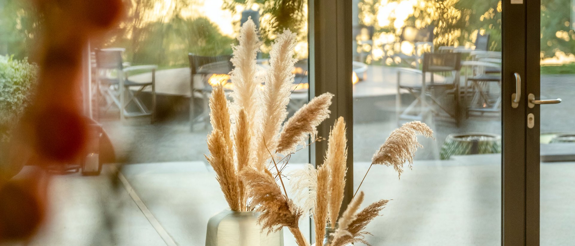 Cozy interior with view of patio and lake at sunset