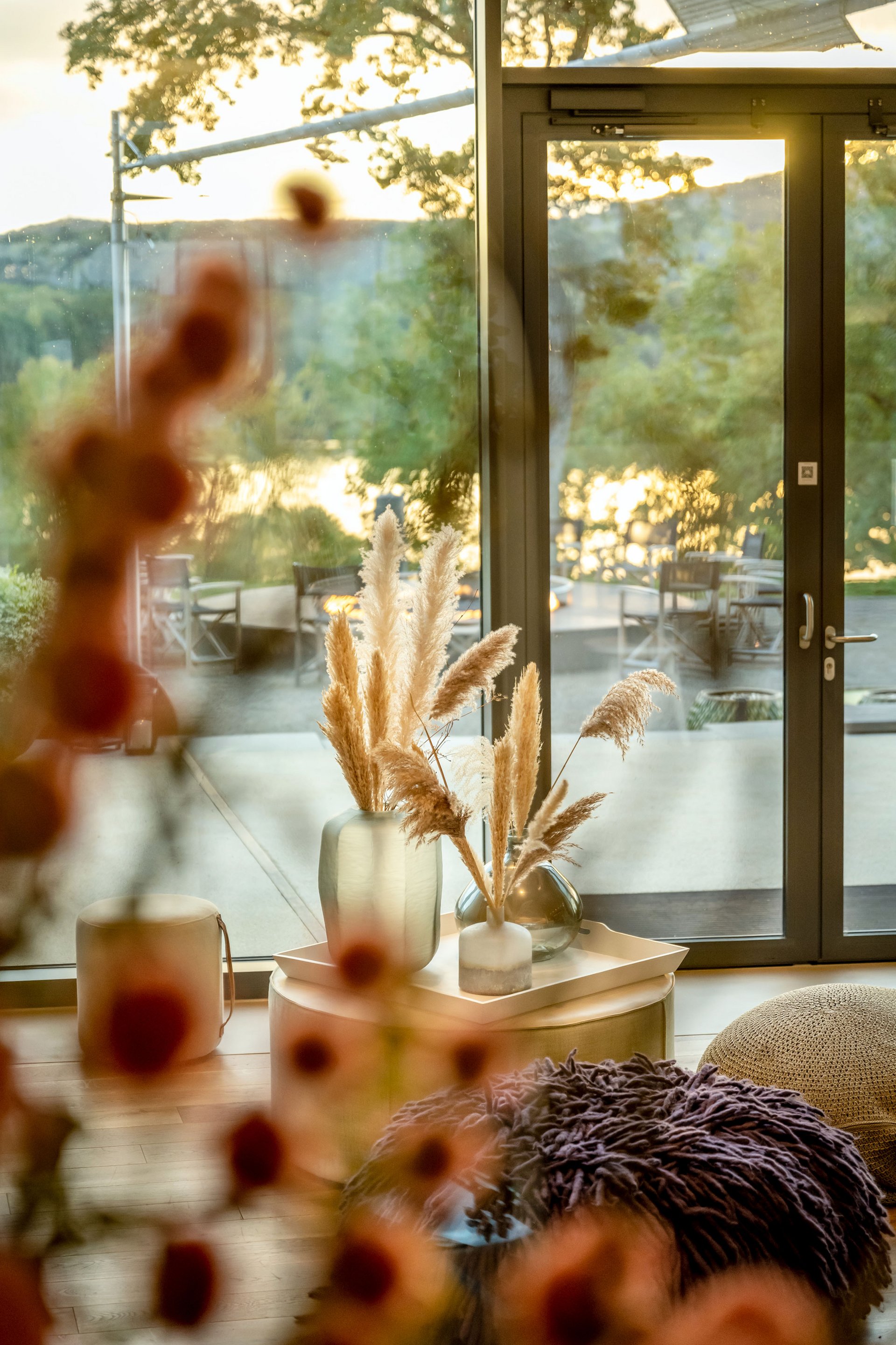 Cozy interior with view of patio and lake at sunset