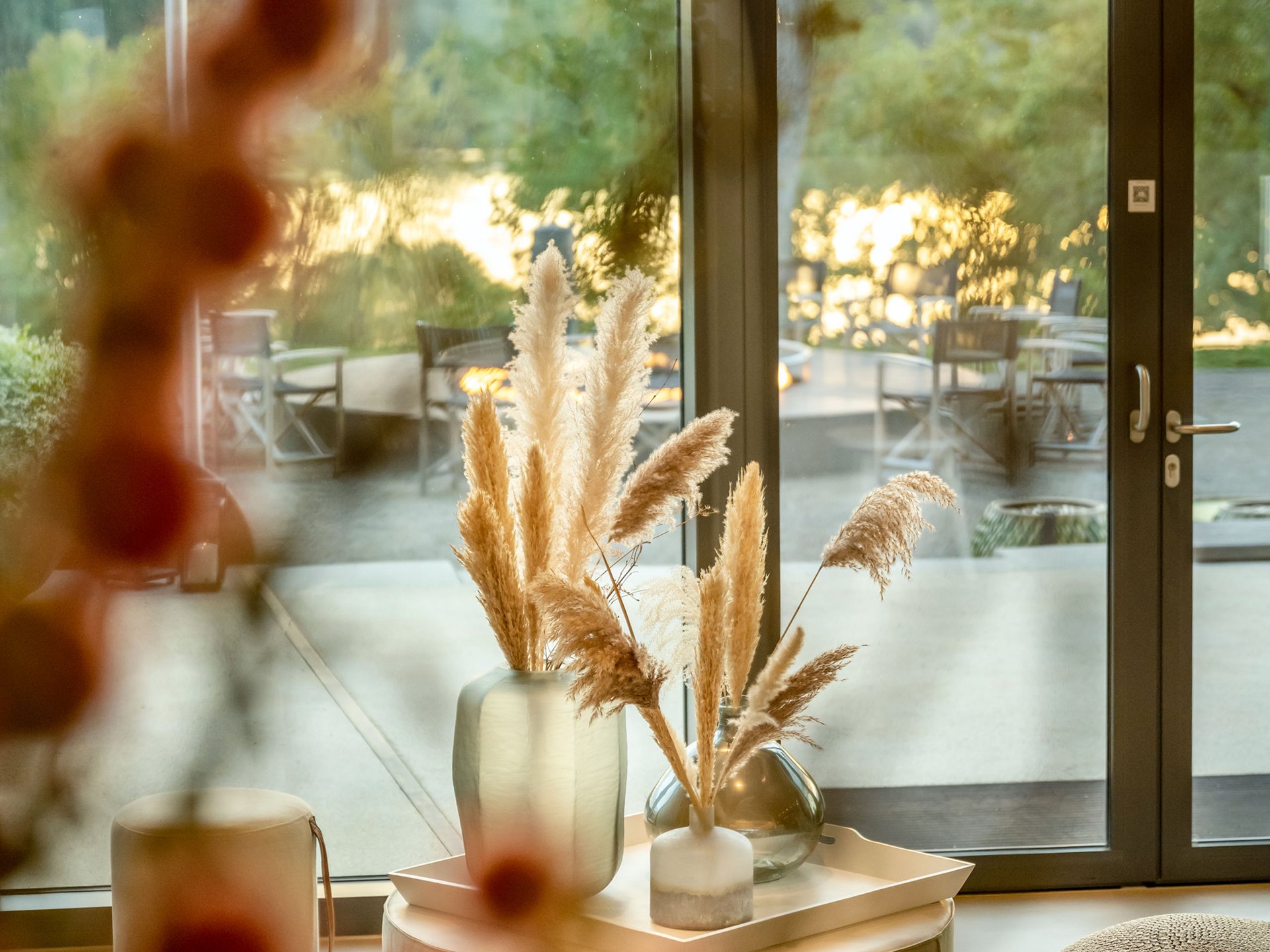 Cozy interior with view of patio and lake at sunset