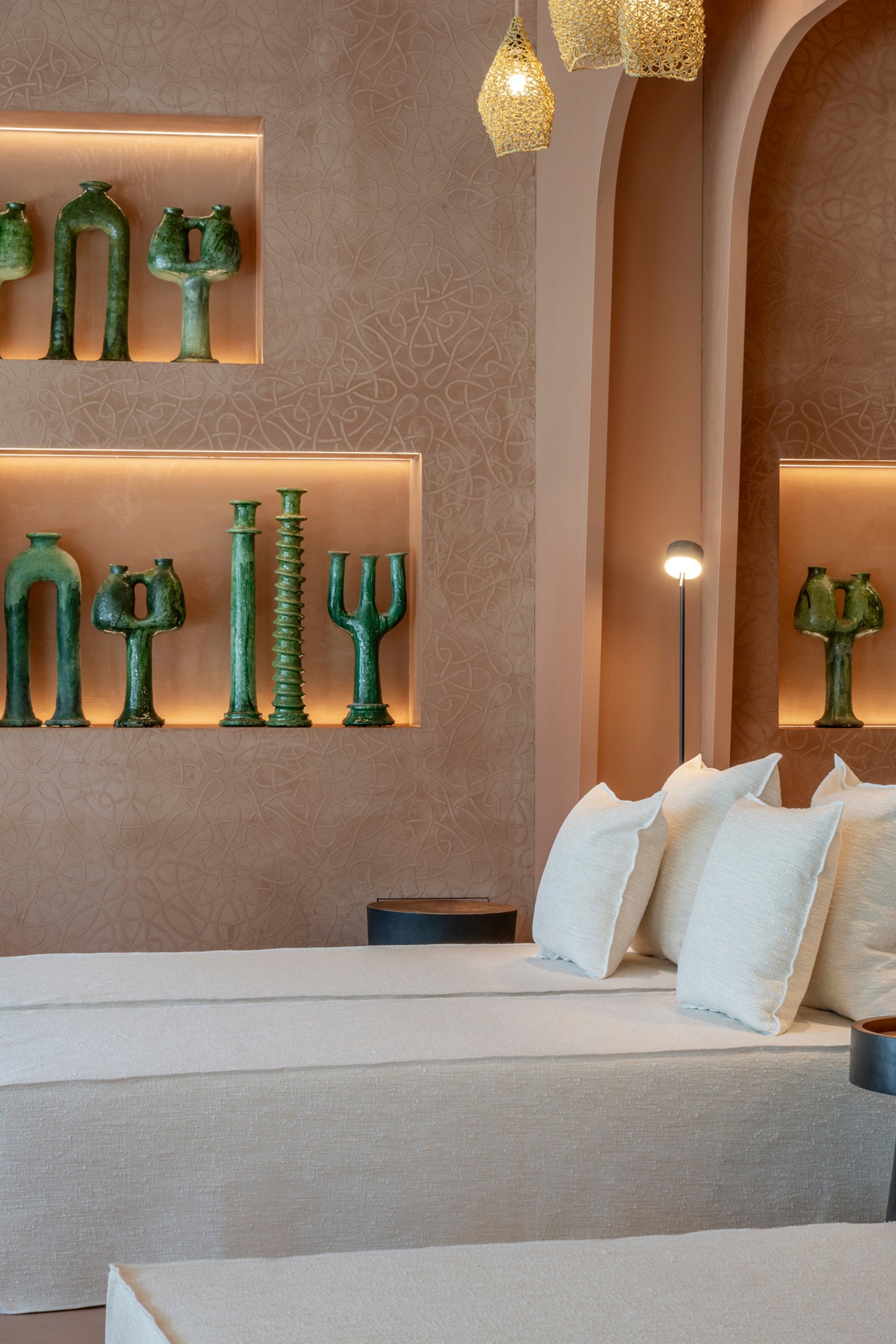 Modern lounge with white sofas and green sculptures on the wall